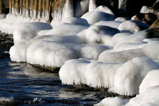 Baltic sea coastline stones covered with ice, cold winter scene