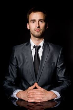 confident businessman with his palms crossed
