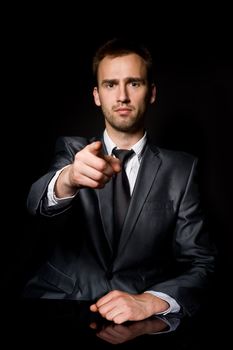 young confident man pointing his finger at you