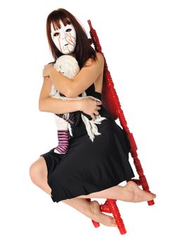 woman in a mask with a doll posing on a white background