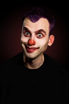 smiling funny male clown over gradient background