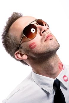 young man with kiss imprints on cheek and shirt