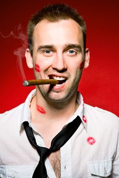 young confident man with cigaro and lips imprints