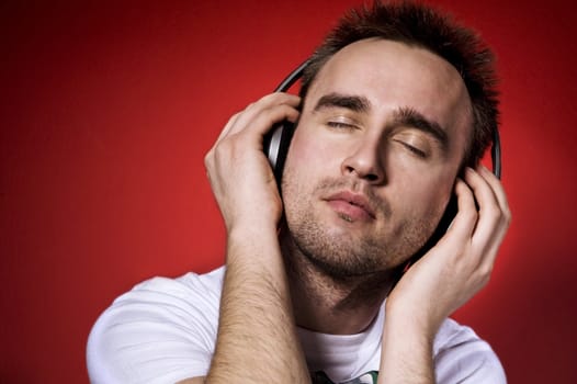 young man listening to the music with eyes closed