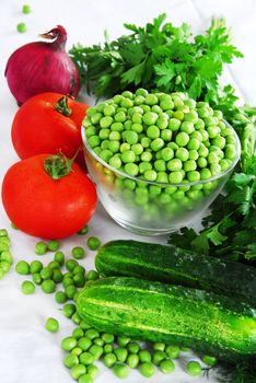 food ingredients, appetizing fresh vegetables, green peas, cucumber and red tomatoes
