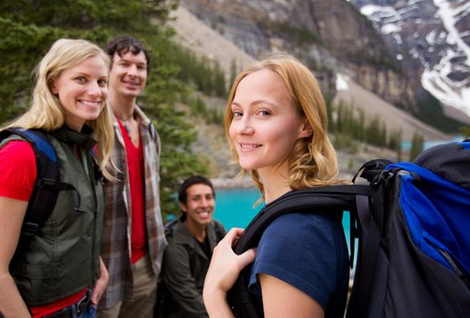 A group of friends hiking with a mountain landscape in the background