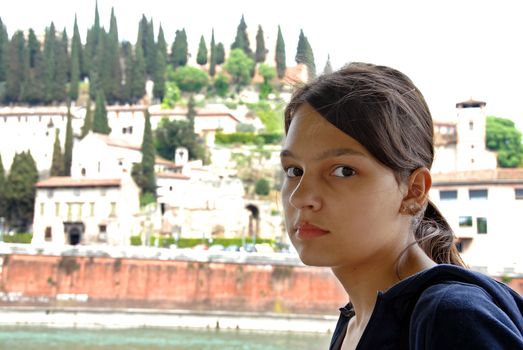portrait of teenage girl tourist over Castel San Pietro in Verona, Italy