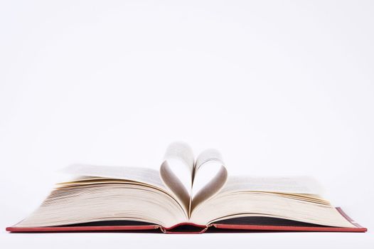 book with heart shaped pages over white background