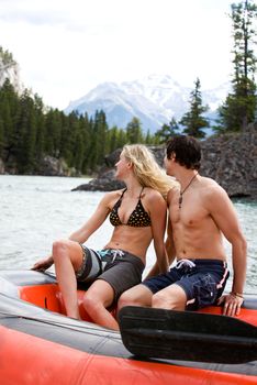 A happy excited couple on a river raft