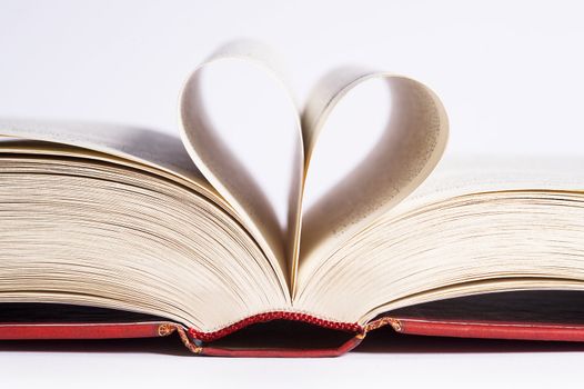 book with heart shaped pages over white background