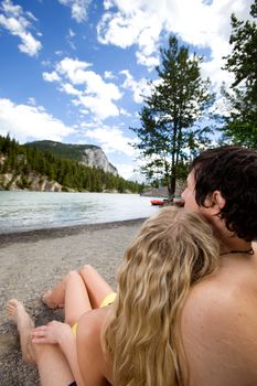 A couple relaxing near a river in Banff, Canada