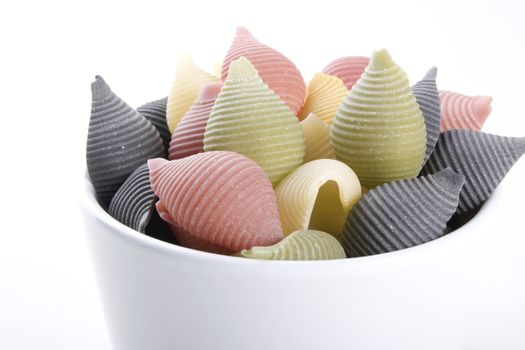 Colorful pasta shells in small bowl. 