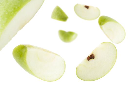 Apple slices falling away from the camera.  Shallow depth of field.