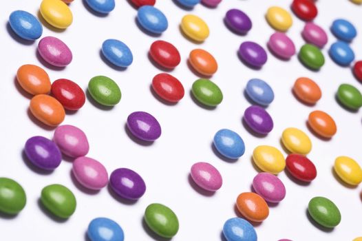 colorful pills scattered on white background
