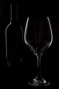 Outlines of wine bottle and wine glass on black
