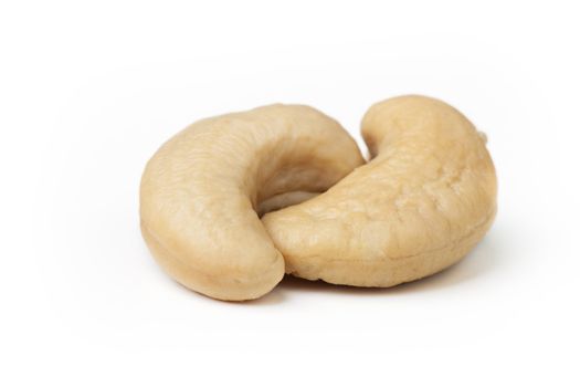 Two cashew nuts on white background