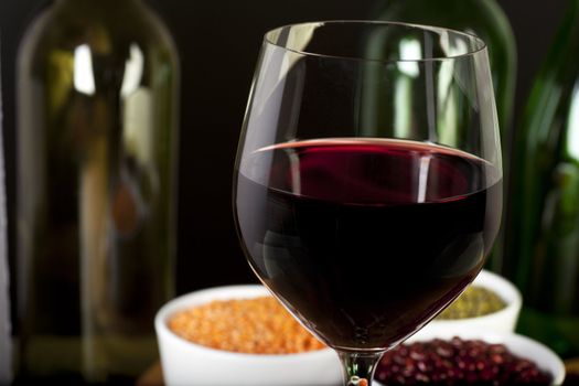 Closeup of glass of red wine  on table, with shallow depth of field