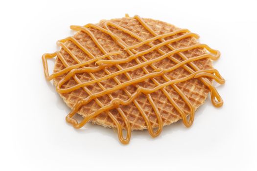 Dutch stroopwafel with caramel topping isolated on white background.