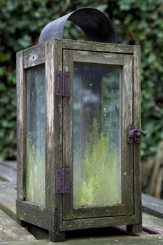 Worn and weathered wooden table lantern.