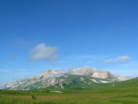 Mountains, rocks; a relief; a landscape; a hill; a panorama; Caucasus; top; a slope; a snow, a cool, clouds; the sky