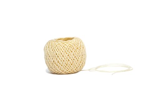 A ball of string unwinding partly on a white background