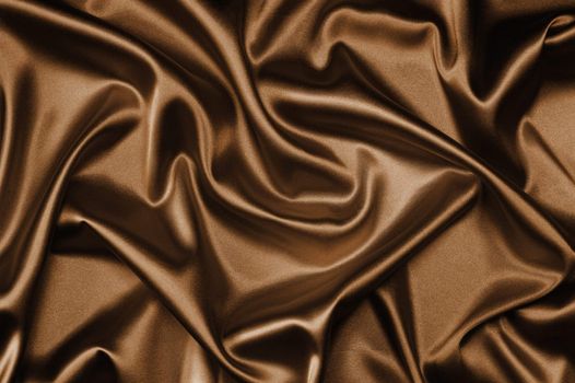 textile brown silk background draped in waves
