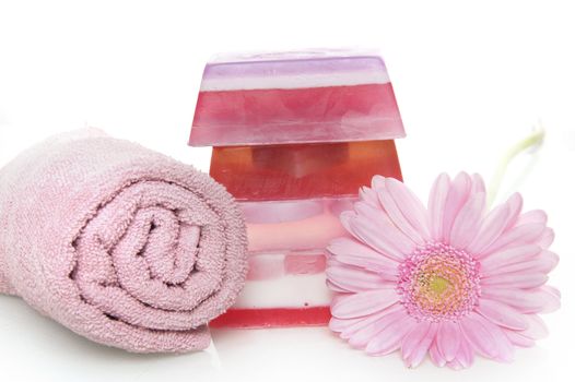 a towel with a pile of soap and  a flower