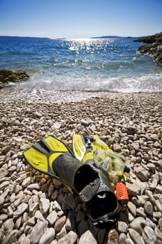 snorkel equipment on a rocky beach