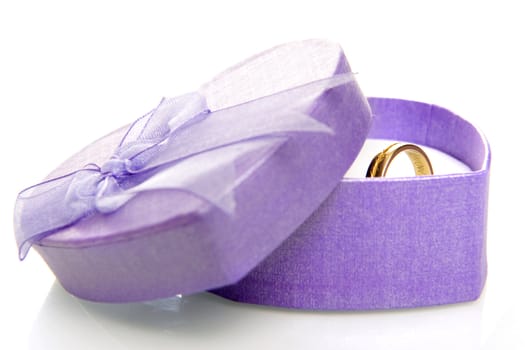a purple heart box with a golden ring on a white background