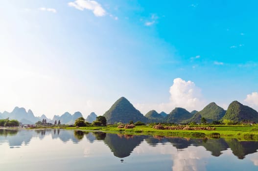 Reflection of the muntains in Li River landscape in morning light, Yangshuo near Guilin,