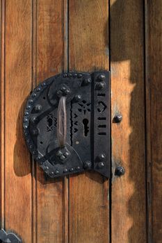 Closeup of old wooden door with nice metal doorknob