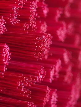 Closeup of a pile of pink joss stick in a buddhist temple