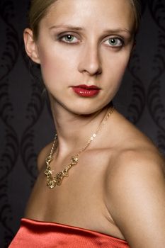 elegant woman wearing golden jewelry, over wallpaper background