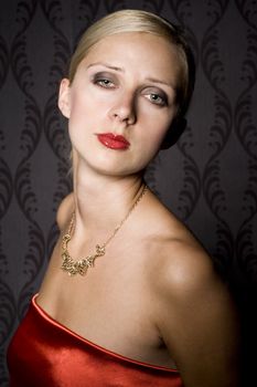 portrait of elegant woman wearing golden necklace, over wallpaper background