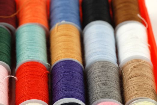 colorful spools of multi colored threads for sewing and knitting