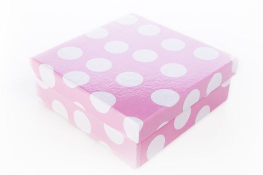 White polka dots on pink decorative gift box.