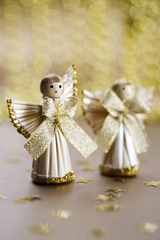 christmas decoration, straw angels with gold bokeh