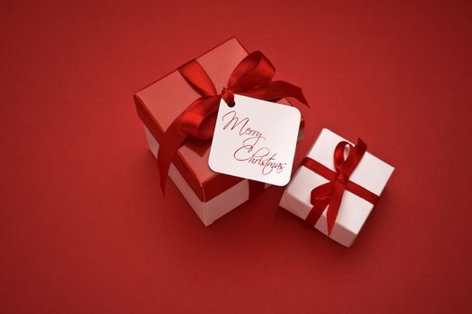 christmas gifts with decorative ribbon on red background