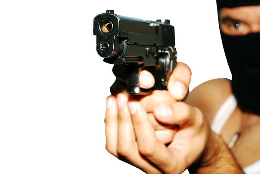 Young man holding up a gun with the focus on his gun isolated.