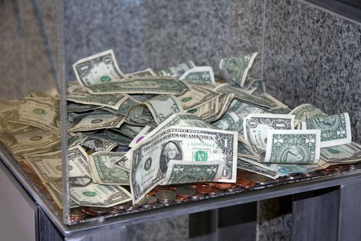 US Dollar in a plexi glass donation box