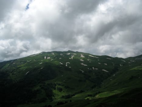 Mountains, rocks; a relief; a landscape; a hill; a panorama; Caucasus; top; a slope; a snow, a cool, clouds; the sky