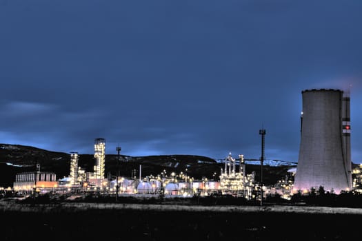 View of large petrochemical factory in early night light with shining lights