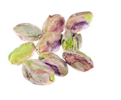 A closeup shot of a bunch of peeled Pistachio nuts. Isolated over white. 