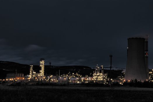 View of large petrochemical factory in early night light with shining lights