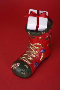 santa's boot with gift on red background