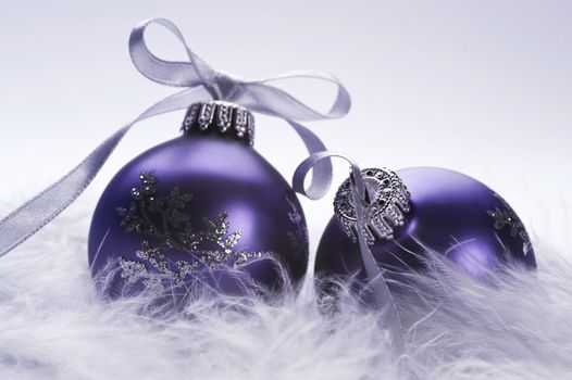 christmas balls with decorative silver ribbon on feather