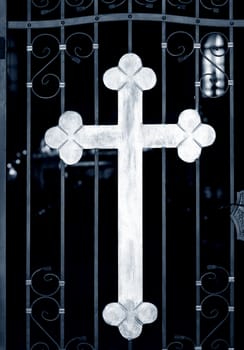 Old metal church doors with big iron cross