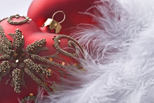 christmas heart shaped balls on feather in macro close up