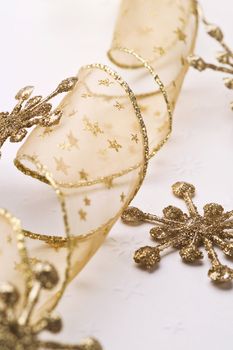 christmas decoration, golden ribbon and stars on white background
