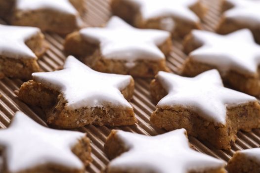 star shaped christmas cookies on paper background, close up